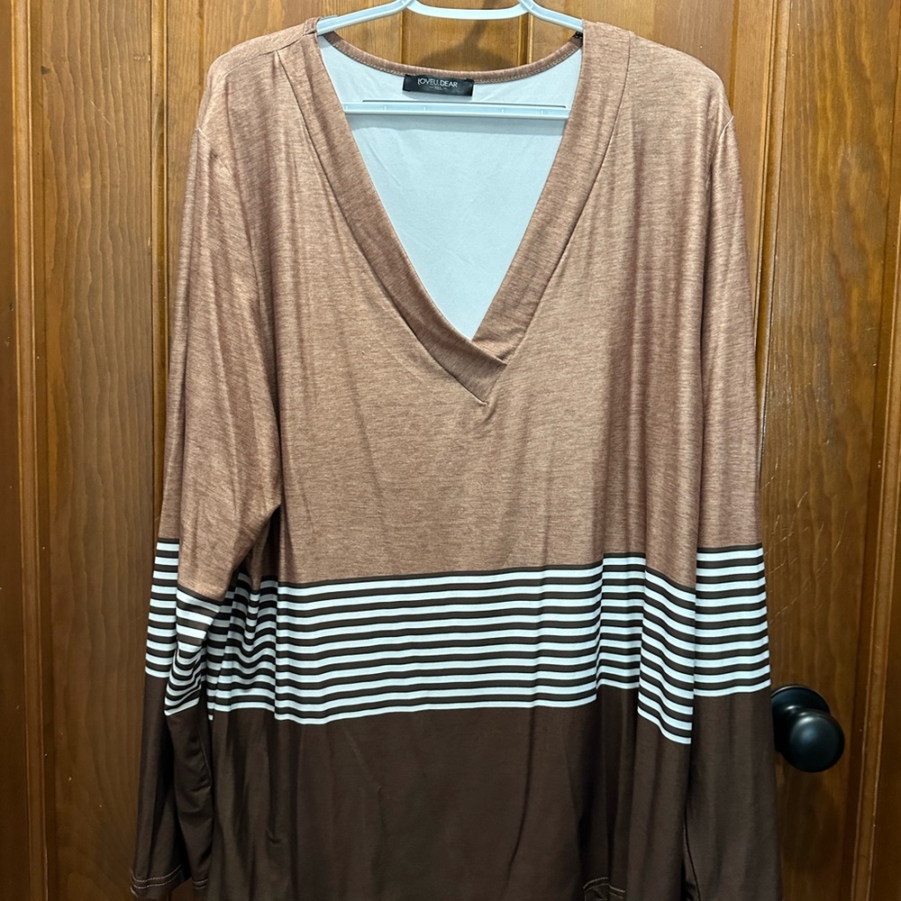 Plus size top. -  Size 2X. Top consists of multiple colors in the brown family.